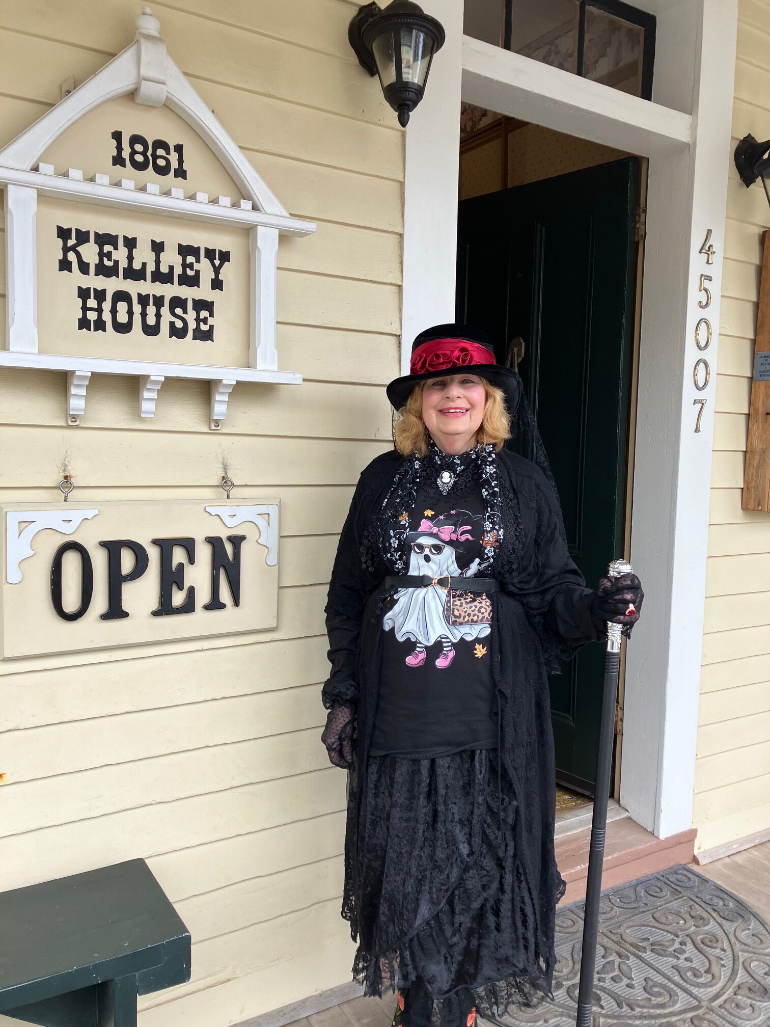 woman in ghost shirt by museum sign