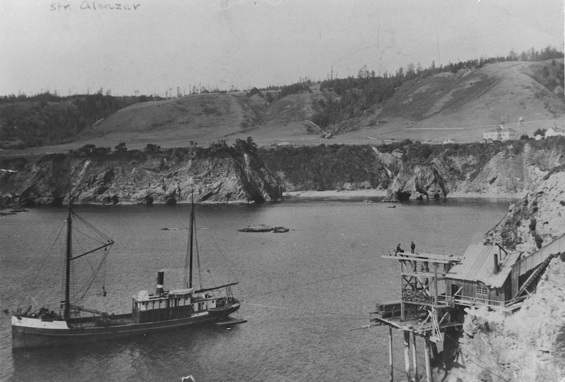 Black and white photo of ship in cove