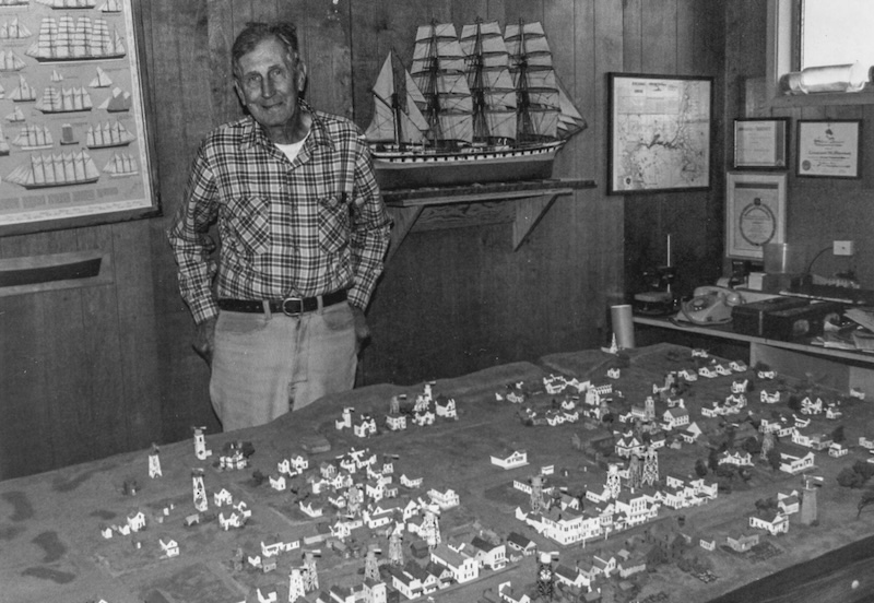 Man stands behind a table-top town model