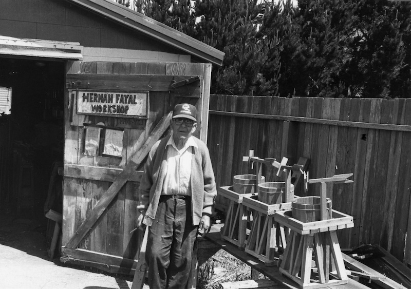 Man standing in front of open workshop door