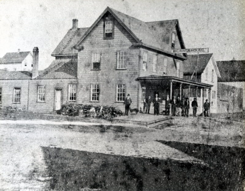 Men in front of a large hotel building