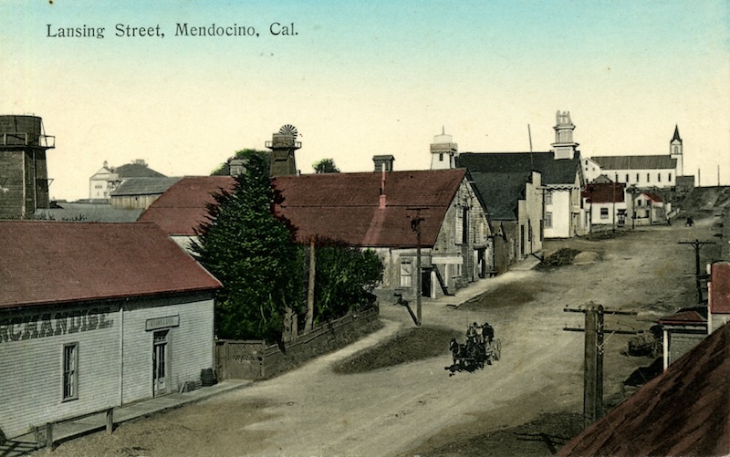 Colorized postcard looking up an unpaved street