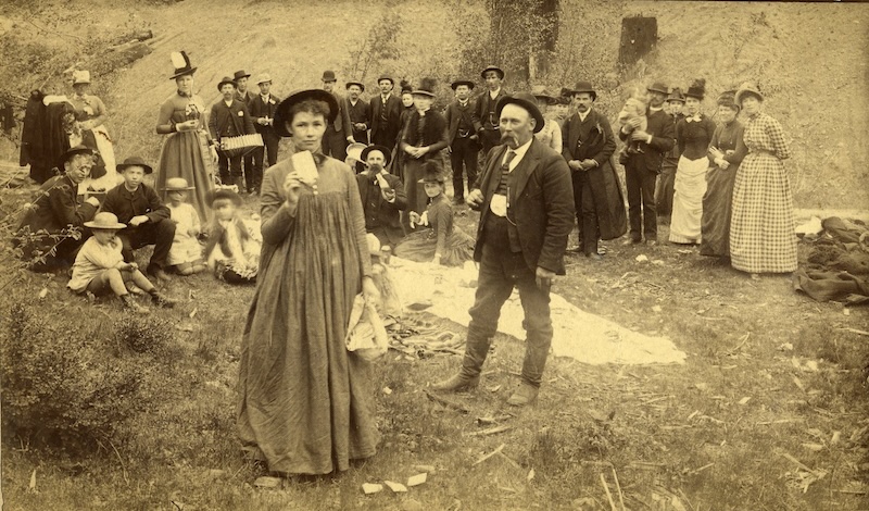 Crowd standing outdoors in fancy dress