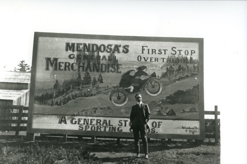 Man standing in front of billboard